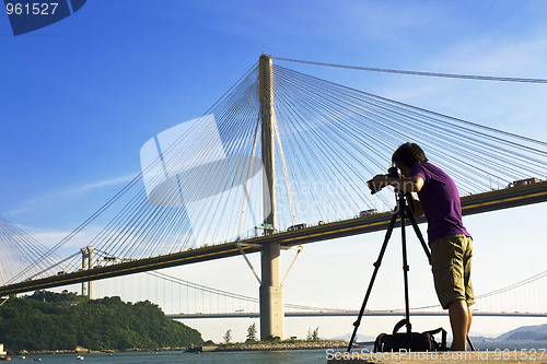 Image of man take photo of the bridge