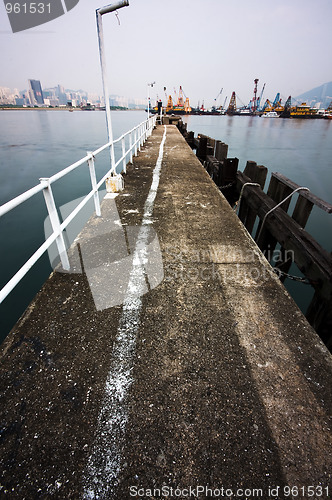 Image of Deserted jetty at a foggy sea near a dutch city. 