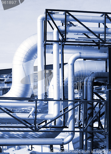 Image of Pipes, tubes, machinery and steam turbine at a power plant 