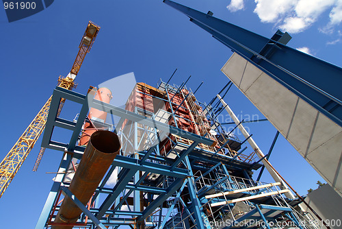 Image of cranes and beams on construction of industrial factory