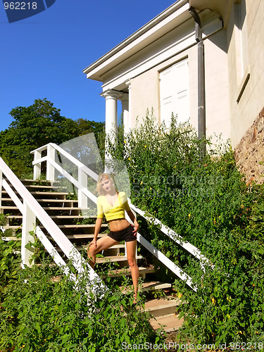 Image of Lady standing on white wooden steps.