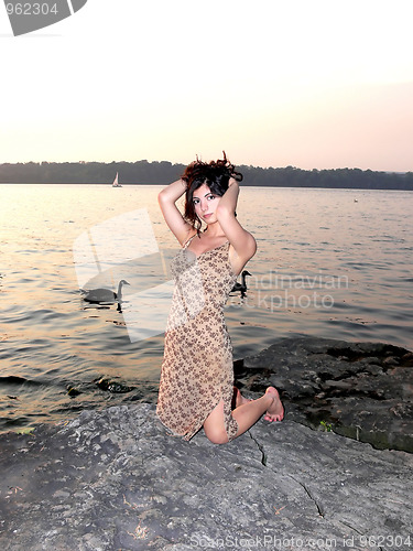 Image of Lady on the lake in sunset 