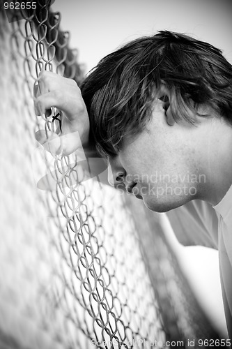 Image of Teen against fence