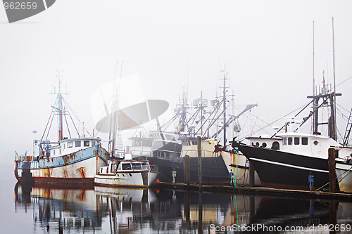 Image of fishing boats in harbor fog