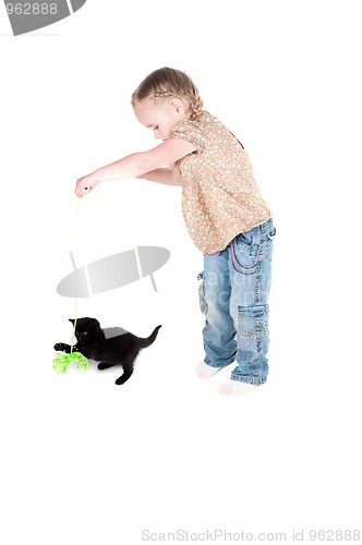 Image of Little girl playing with kitten