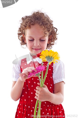 Image of girl sniffs some flowers