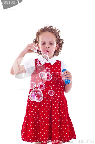Image of little girl blowing soap bubbles 