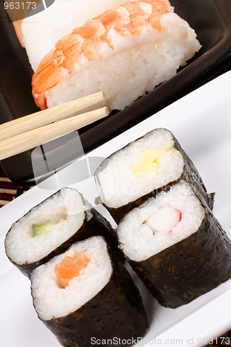 Image of Assorted sushi with chopsticks