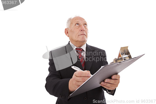 Image of senior businessman writing