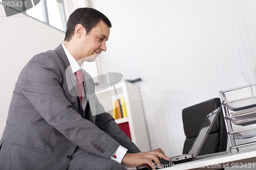 Image of Mature businessman working at the office