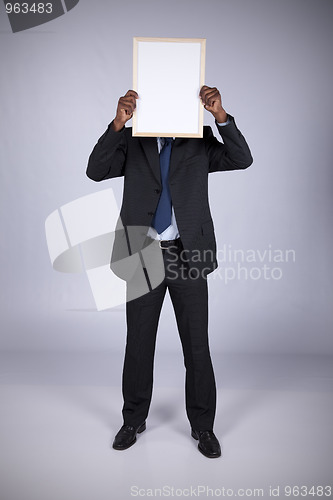 Image of african businessman holding a whiteboard