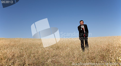 Image of Businessman shouting at the megaphone to you