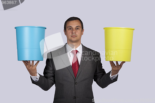 Image of Businessman holding buckets