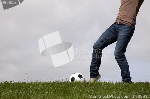 Image of Human foot and a soccer ball