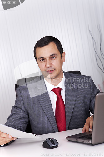 Image of Mature businessman working at the office