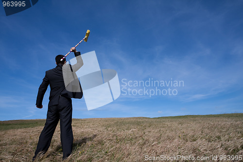 Image of businessman cleaning the environment