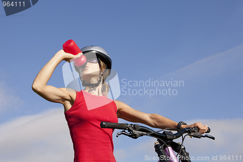 Image of Woman drinking water in her bike