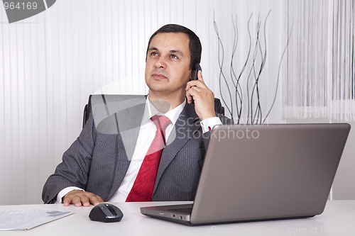 Image of Mature businessman working at the office