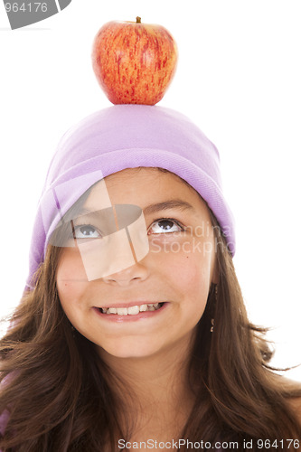 Image of young child with an apple on her head