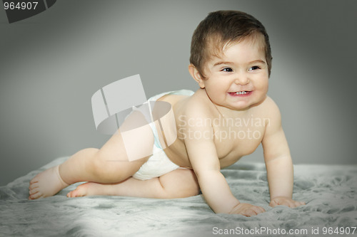 Image of Baby sitting on gray carpet