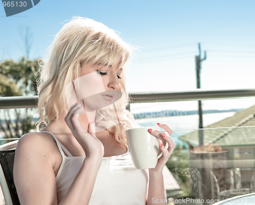 Image of young woman having coffee