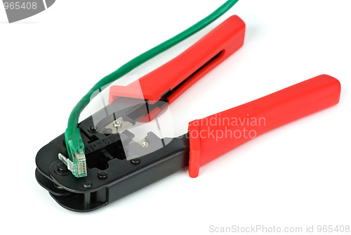 Image of Crimping cutting tool and green patchcord