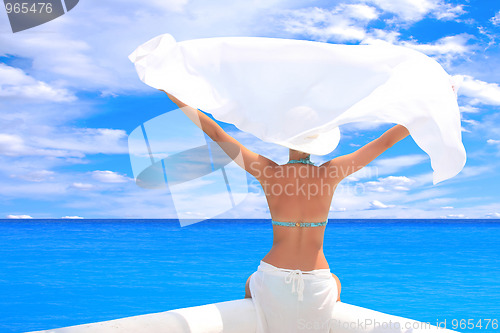 Image of woman relaxing by the sea