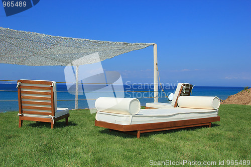 Image of Sunbeds at the beach of luxury hotel