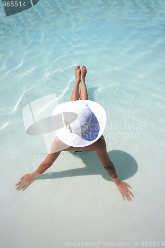 Image of Woman in a pool hat relaxing