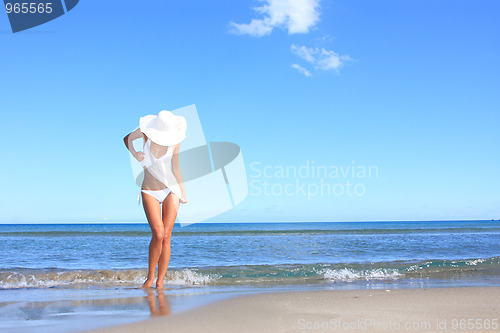 Image of Young woman standing on a beach 