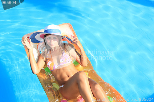 Image of Young woman in the pool 