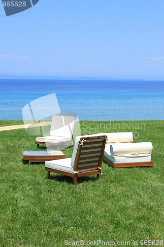 Image of Sunbeds at the beach of luxury hotel