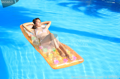 Image of Young woman in the pool 