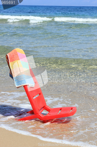 Image of An empty chair on a  beach 