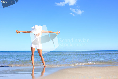 Image of Young woman standing on a beach 