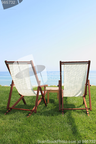 Image of Sunbeds at the beach of luxury hotel