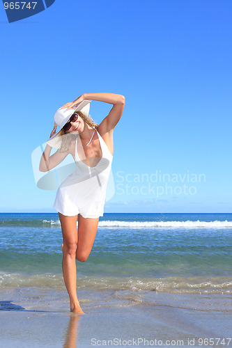 Image of Young woman standing on a beach 