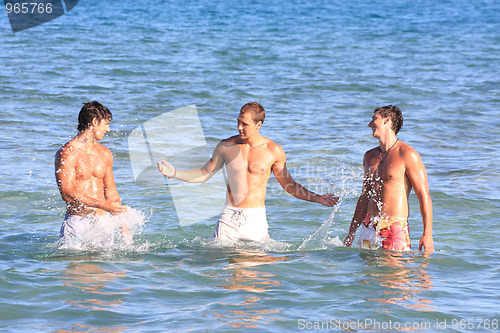 Image of Men Relaxing On the Beach