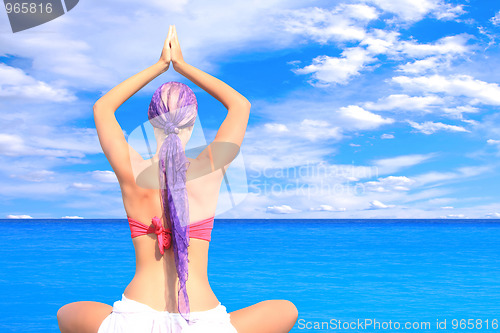 Image of woman relaxing by the sea