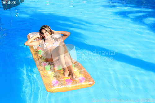 Image of Young woman in the pool 
