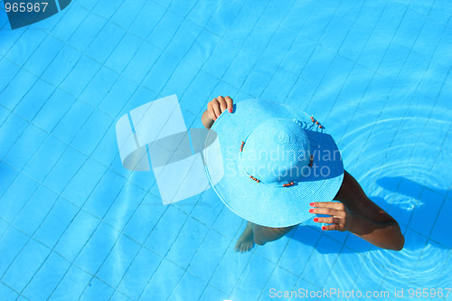 Image of Young woman in the pool 