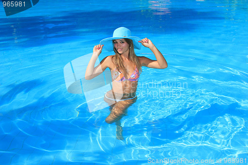 Image of Young woman in the pool 