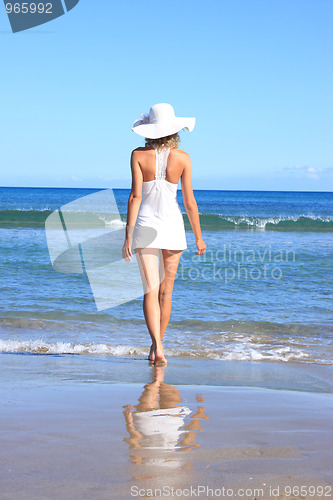Image of Young woman standing on a beach 