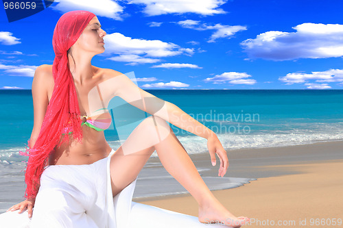 Image of woman relaxing by the sea