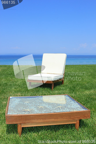 Image of Sunbeds at the beach of luxury hotel