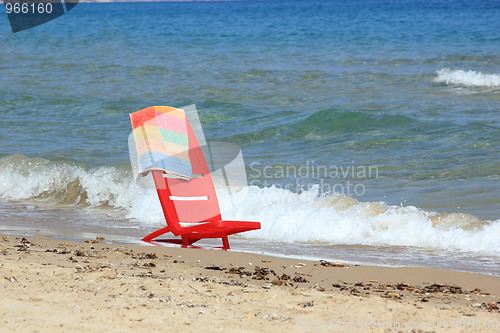 Image of An empty chair on a  beach 