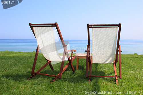 Image of Sunbeds at the beach of luxury hotel