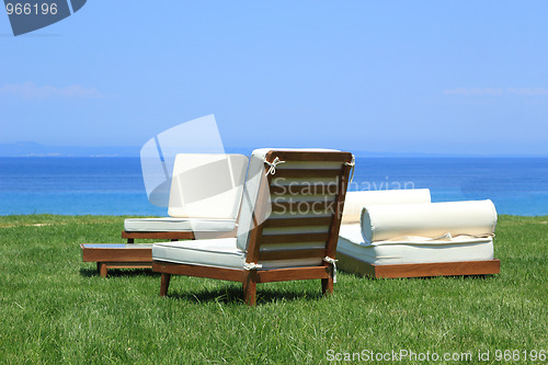 Image of Sunbeds at the beach of luxury hotel