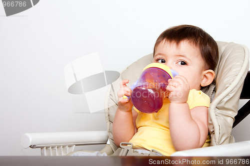 Image of Baby infant drinking from sippy cup