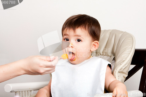 Image of Happy baby spoon feeding